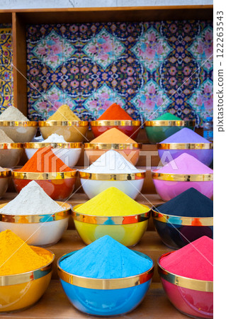 Traditional spices market. Pots and wooden tubs stand in row with colorful tea, spices, fruits, roots, flowers. Street bazaar. Dubai, UAE. Vertical photo 122263543