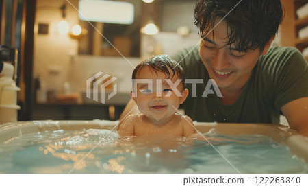Father and baby enjoying a joyful moment together in a cozy indoor space during bath time 122263840