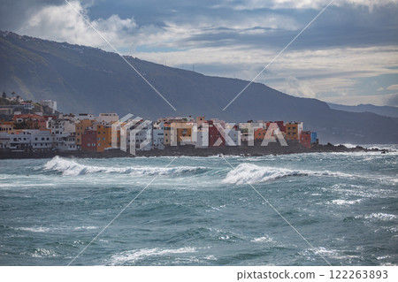 storm at sea with the city of Puerto de la Cruz in the background. storm at sea with the city of Puerto de la Cruz in the background. 122263893