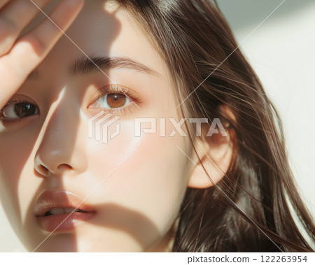 A beauty and fashion photoshoot with a close-up of half the face of a beautiful young Asian woman with beautiful skin. A beauty and fashion photoshoot with a close-up of half the face of a beautiful young Asian woman with beautiful skin. 122263954