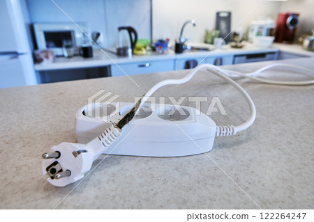 Overload burned out wires and insulation of extension cord with tee. Overload burned out wires and insulation of extension cord with tee. 122264247