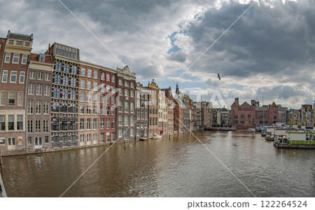 houses by a water canal in Amsterdam. houses by a water canal in Amsterdam. 122264524