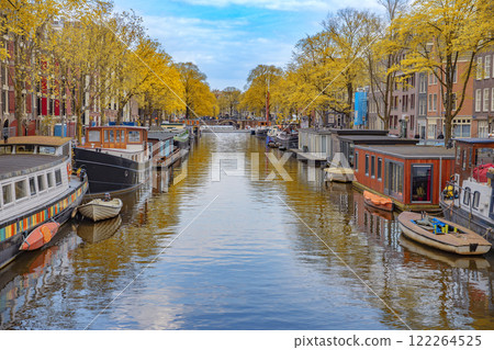 houses by a water canal in Amsterdam in autumn. 122264525