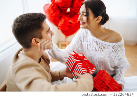 Exchange of gifts. Romantic day together. Valentines day, couple, relationships and people concept. 122264634
