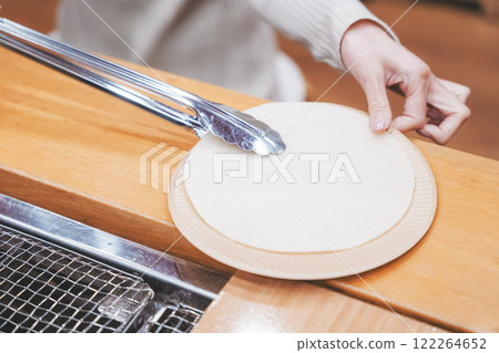 A young woman trying out hand-baked rice crackers [Photo courtesy of Niigata Rice Crackers premium SENBEI DEN] 122264652