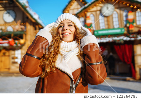 Happy woman posing at a festive street market. Holiday concept, relaxation. Happy woman posing at a festive street market. Holiday concept, relaxation. 122264785