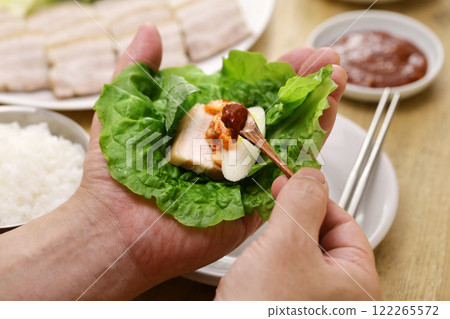 Bossam (sliced pork belly wrapped in leafy vegetables), Korean food Bossam (sliced pork belly wrapped in leafy vegetables), Korean food 122265572