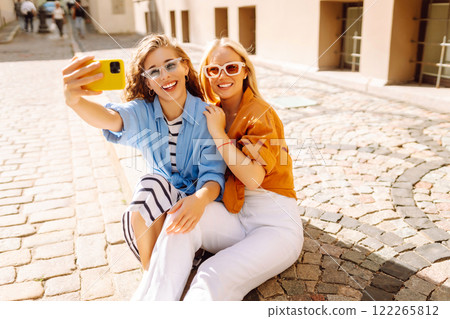 Young friends having fun and take selfie on the phone together. Entertainment, youth concept. 122265812