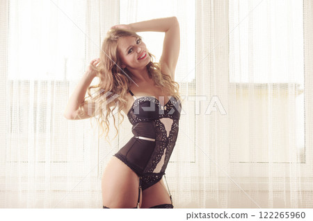Woman wearing lingerie posing in curtain 122265960