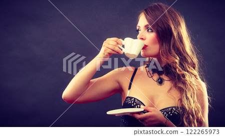 Model wearing lingerie with beverage 122265973