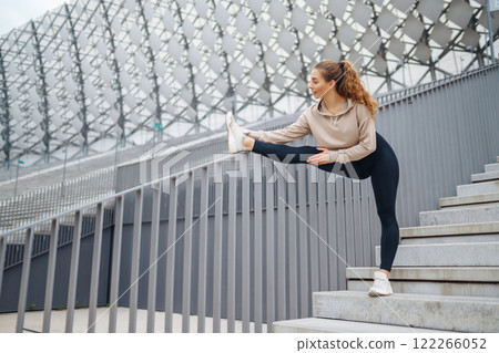 Active lifestyle. Young fitness woman exercising and stretching outdoors. Sports, sports training. Active lifestyle. Young fitness woman exercising and stretching outdoors. Sports, sports training. 122266052