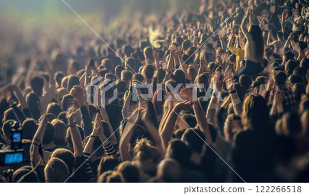 People raised their hands up to the music at a concert of their favorite band 122266518