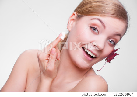 Skin care. Face of young woman girl with red maple leaf. Skin care. Face of young woman girl with red maple leaf. 122266964