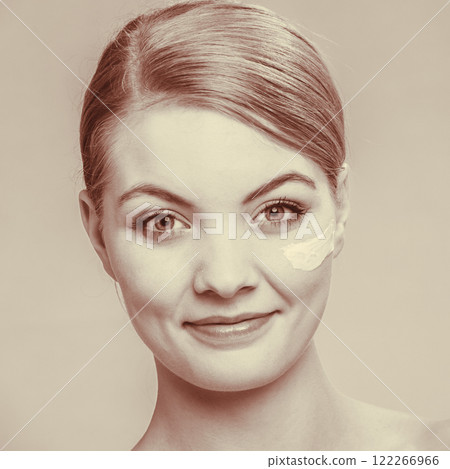 woman applying cream on her skin face. woman applying cream on her skin face. 122266966
