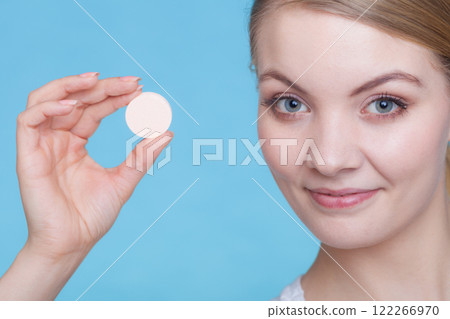 Woman hand holding big effervescent pill 122266970