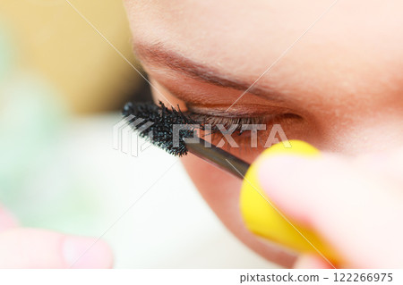 Close up woman getting make up, mascara 122266975