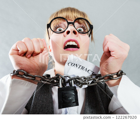 Furious woman with chained hands and contract 122267020