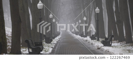 park with trees and benches in fog Minsk . 122267469