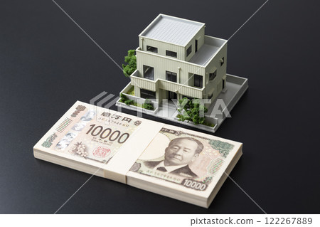 House model and money on black background 122267889