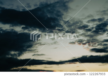Dusky dark blue yellow sunset sky. Evening cloudscape in twilight. Full sky with last sunshine light and dark blue contrast clouds Majestic sky cloud 122267933