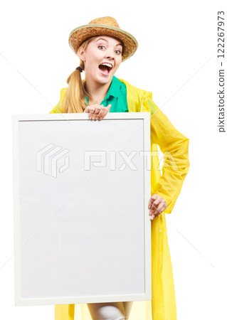 Happy cheerful woman holding blank white board Happy cheerful woman holding blank white board 122267973