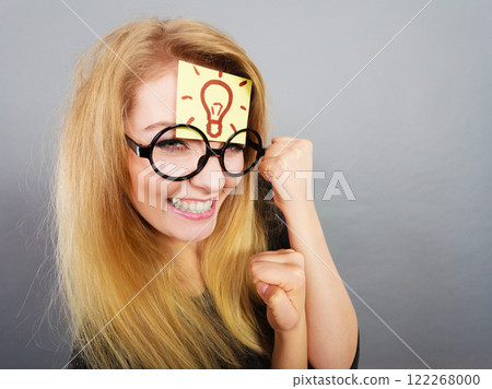 Woman having light bulb mark on forehead thinking Woman having light bulb mark on forehead thinking 122268000