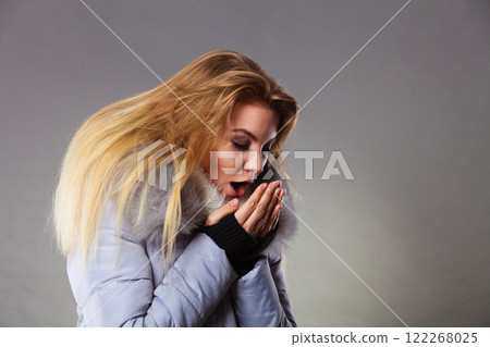 Woman wearing winter warm furry jacket Woman wearing winter warm furry jacket 122268025
