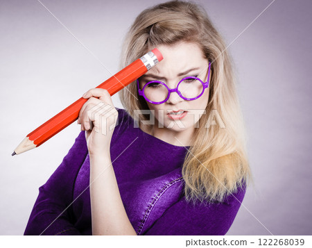 Woman confused thinking, big pencil in hand 122268039