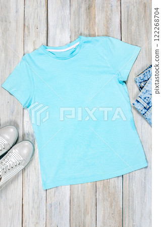 T-shirt mockup on wooden background. Perfect for displaying t-shirt designs. 122268704