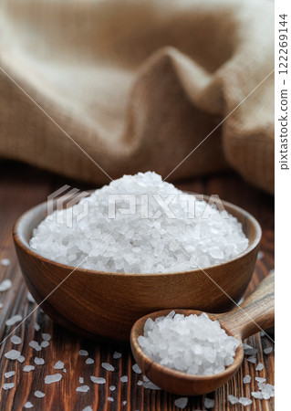 sea salt in bowl and in spoon on table with burlap on the background sea salt in bowl and in spoon on table with burlap on the background 122269144