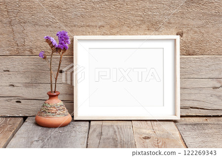 Wooden frame 8x10 on wooden background. Ideal for displaying your artwork. Wooden frame 8x10 on wooden background. Ideal for displaying your artwork. 122269343