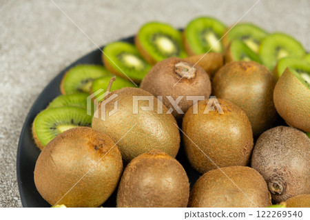 Plate of sliced and whole fresh kiwi fruit. Plate of sliced and whole fresh kiwi fruit. 122269540