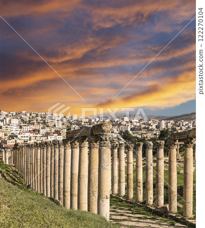 Roman Columns in the Jordanian city of Jerash (Gerasa of Antiquity), capital and largest city of Jerash Governorate, Jordan. Against the background of a beautiful sky with clouds 122270104