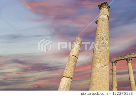 Roman Columns in the Jordanian city of Jerash (Gerasa of Antiquity), capital and largest city of Jerash Governorate, Jordan. Against the background of a beautiful sky with clouds Roman Columns in the Jordanian city of Jerash (Gerasa of Antiquity), capital and largest city of Jerash Governorate, Jordan. Against the background of a beautiful sky with clouds 122270158