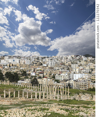 Roman ruins (against the background of a beautiful sky with clouds) in the Jordanian city of Jerash (Gerasa of Antiquity), capital and largest city of Jerash Governorate, Jordan 122270342