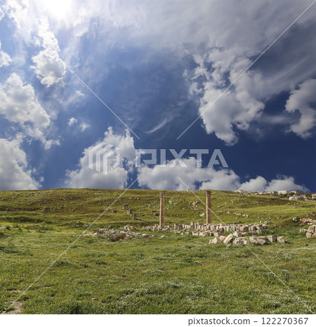 Roman ruins (against the background of a beautiful sky with clouds) in the Jordanian city of Jerash (Gerasa of Antiquity), capital and largest city of Jerash Governorate, Jordan Roman ruins (against the background of a beautiful sky with clouds) in the Jordanian city of Jerash (Gerasa of Antiquity), capital and largest city of Jerash Governorate, Jordan 122270367