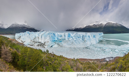 Perito Moreno Glacier with its dramatic icy wall and surrounding snowy mountains in Patagonia 122270622