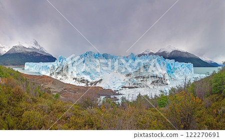 Perito Moreno Glacier with its dramatic icy wall and surrounding snowy mountains in Patagonia 122270691