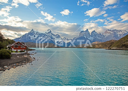 Panoramic view of Lake Pehoe with reflections of dramatic mountains and expansive skies in Torres del Paine 122270751