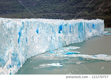 Perito Moreno Glacier with its dramatic icy wall and surrounding snowy mountains in Patagonia 122270757
