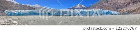 Distant view of Grey Glacier flowing into Lago Grey surrounded by mountains in Torres del Paine 122270767