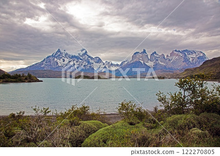 Panoramic view of Lake Pehoe with reflections of dramatic mountains and expansive skies in Torres del Paine 122270805