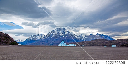View from the far end of Lago Grey with icebergs and dramatic mountain backdrop in Torres del Paine 122270806