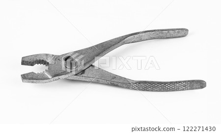 Classic pliers resting on a flat surface 122271430
