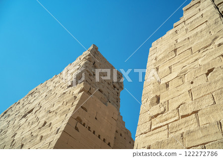 Ancient Egyptian brick block wall in luxor against blue sky 122272786