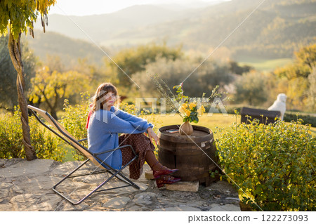 Woman Relaxing on Rustic Patio Woman Relaxing on Rustic Patio 122273093