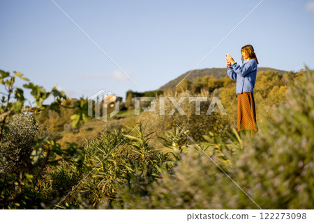 Woman Photographing Countryside 122273098