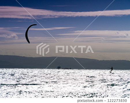 Kite surfer riding waves. Kiteboarding sport. Kite surfer riding waves. Kiteboarding sport. 122273830