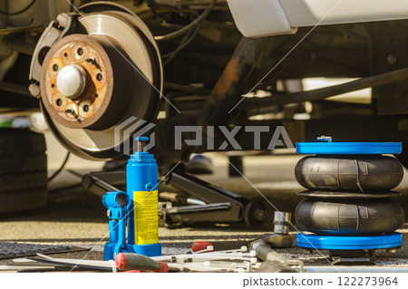 Car in service. Installing air ride suspension. 122273964