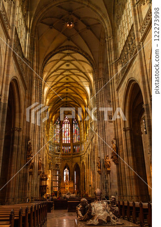 Interior of Gothic Cathedral inside. Carved pulpit, stained-glass Windows through which light rays penetrate building Prague, Czech Republic Interior of Gothic Cathedral inside. Carved pulpit, stained-glass Windows through which light rays penetrate building Prague, Czech Republic 122273998